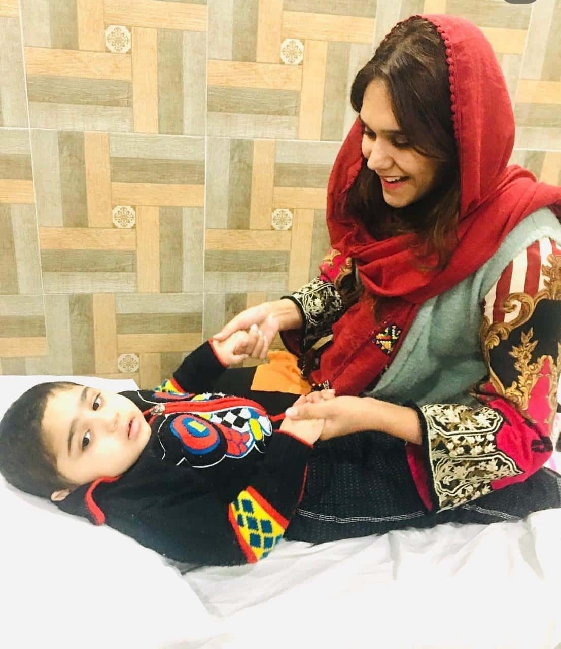 Physiotherapist Dr. Rimsha talking with a patient at a therapy center in Gujrat