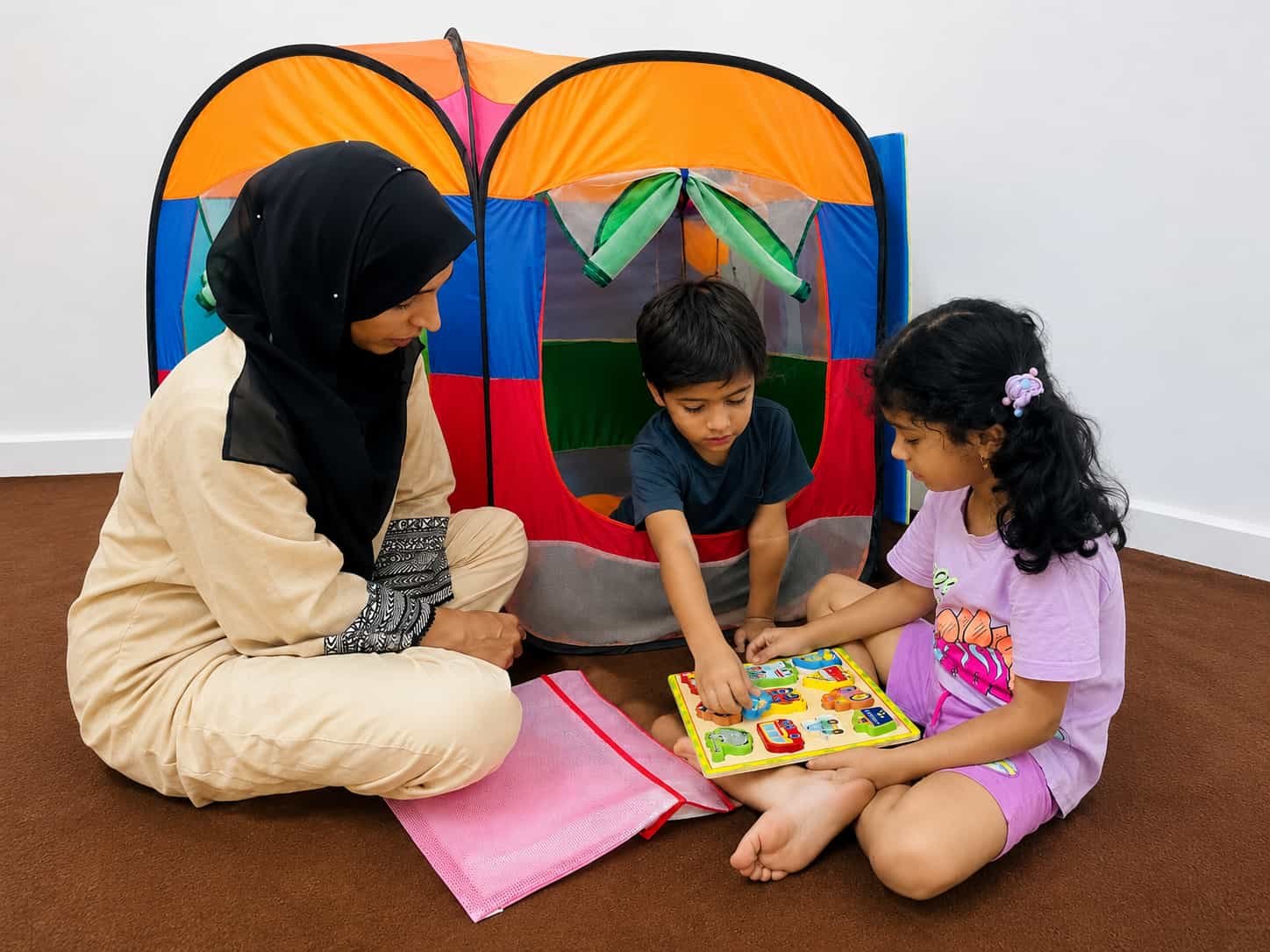 Children practicing fine motor and cognitive skills with a puzzle during an occupational therapy session in Gujrat