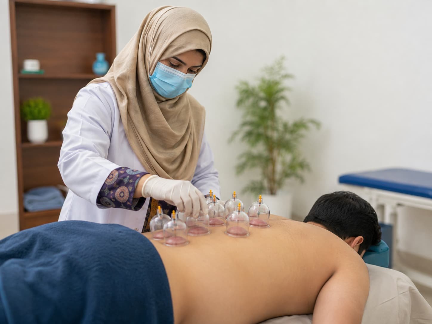 Therapist providing cupping therapy to an adult patient
